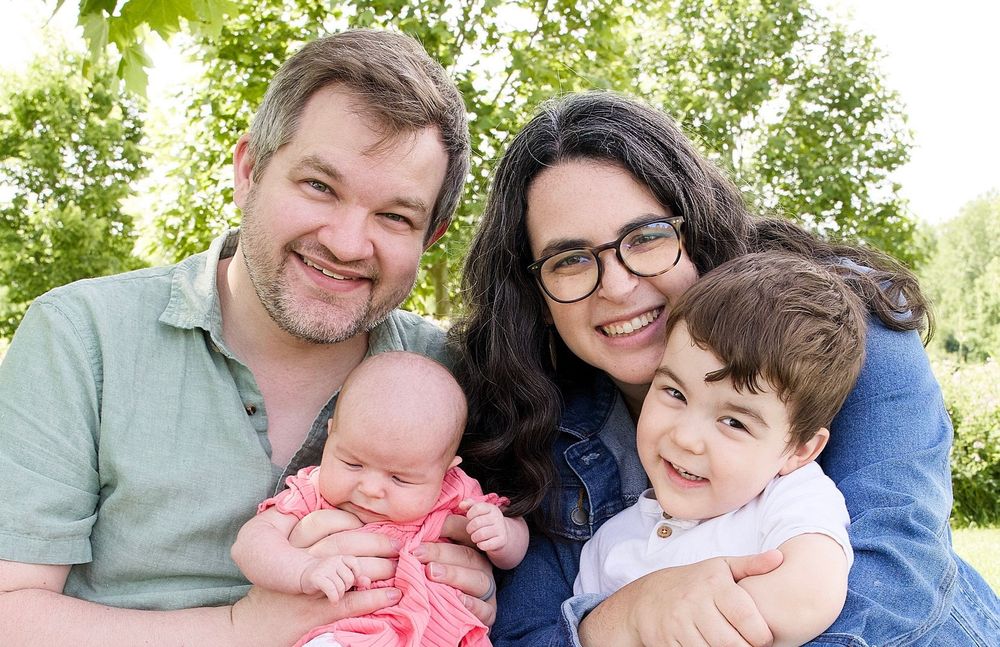 Family photo of the founder with his wife, son and infant daughter outdoors